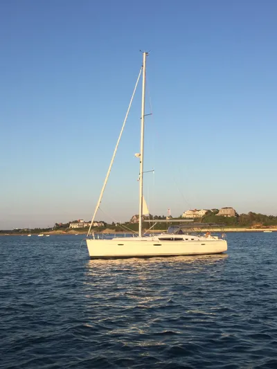  Yacht Photos Pics 2008 Beneteau Oceanis 46 sailboat on calm water, coastal background.