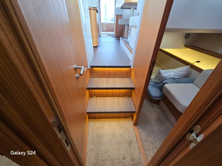 Latitude Adjustment Yacht Photos Pics Interior of 2022 Greenline 39 Hybrid yacht, featuring wooden stairs and cozy seating area.