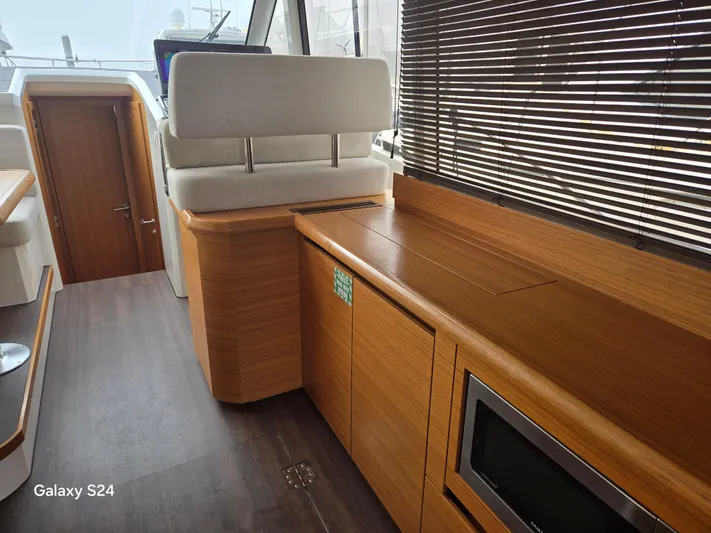 Latitude Adjustment Yacht Photos Pics Interior of 2022 Greenline 39 Hybrid yacht with wooden cabinetry and modern design.