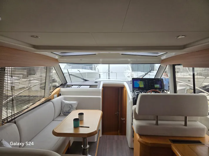 Latitude Adjustment Yacht Photos Pics Interior of 2022 Greenline 39 Hybrid yacht, featuring modern seating and navigation equipment.