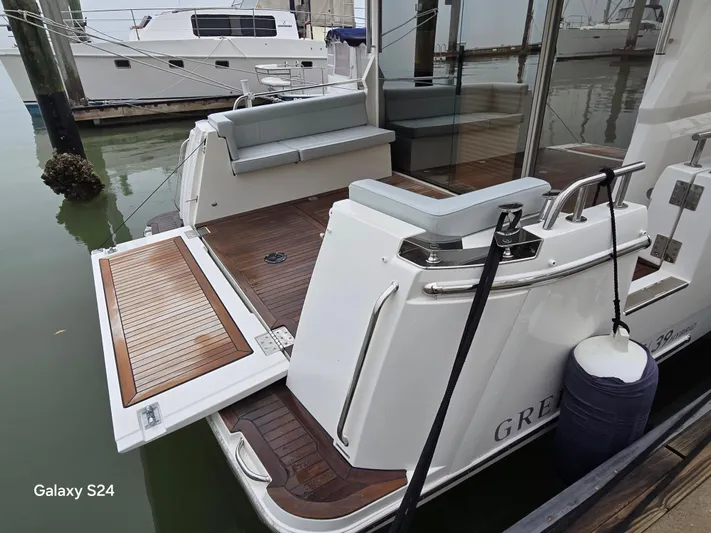 Latitude Adjustment Yacht Photos Pics 2022 Greenline 39 Hybrid yacht with open swim platform and sleek design at dock.