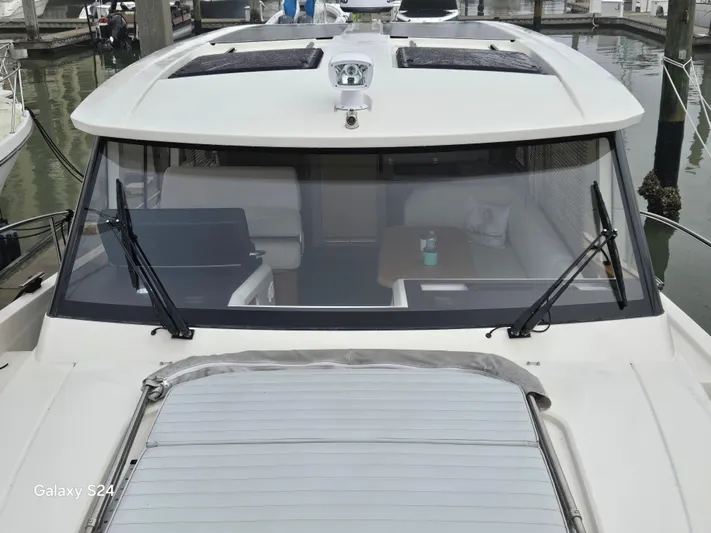 Latitude Adjustment Yacht Photos Pics 2022 Greenline 39 Hybrid yacht docked, showcasing sleek design and spacious interior.