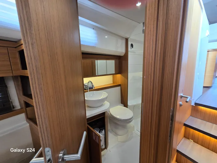 Latitude Adjustment Yacht Photos Pics Luxurious bathroom interior of 2022 Greenline 39 Hybrid yacht, featuring modern wood finishes.