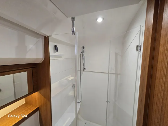 Latitude Adjustment Yacht Photos Pics Modern bathroom interior in 2022 Greenline 39 Hybrid yacht, featuring glass shower enclosure.