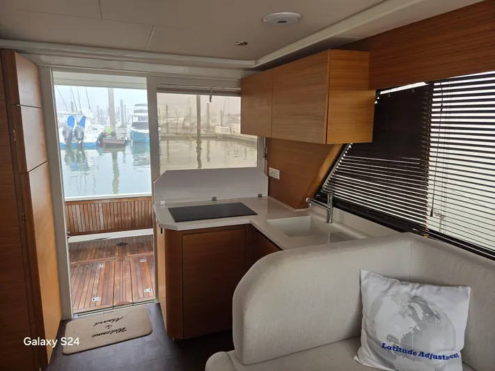 Latitude Adjustment Yacht Photos Pics Interior of 2022 Greenline 39 Hybrid yacht with modern kitchen and marina view.