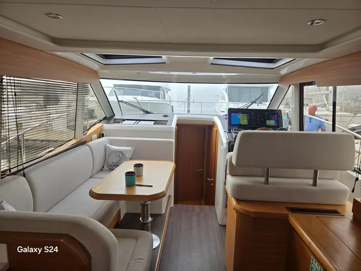 Latitude Adjustment Yacht Photos Pics Interior of 2022 Greenline 39 Hybrid yacht with modern seating and navigation equipment.