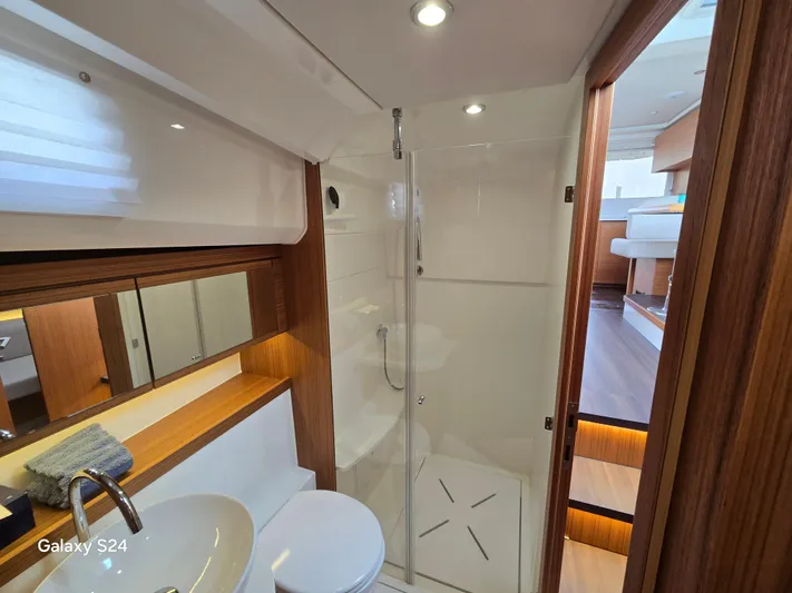 Latitude Adjustment Yacht Photos Pics Luxurious bathroom interior of 2022 Greenline 39 Hybrid yacht, featuring modern fixtures and wooden accents.
