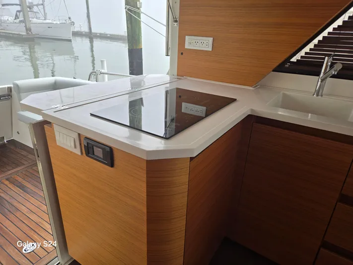Latitude Adjustment Yacht Photos Pics Modern kitchen on 2022 Greenline 39 Hybrid yacht with sleek countertops and appliances.