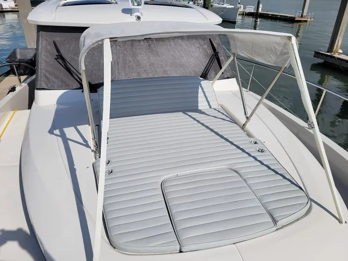 Latitude Adjustment Yacht Photos Pics 2022 Greenline 39 Hybrid yacht with sunbed and canopy, docked at marina.