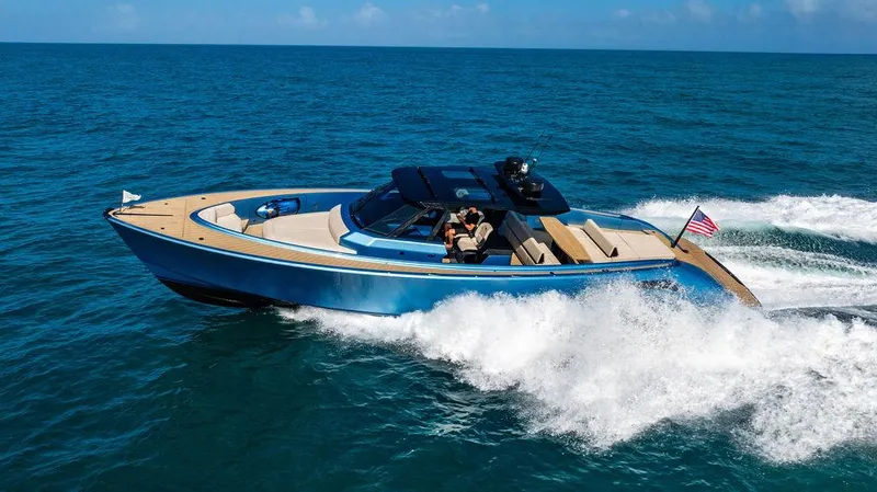 Elizabeth Yacht Photos Pics Luxury Wajer 55 S yacht cruising on open sea, 2022 model, with sleek design and American flag.