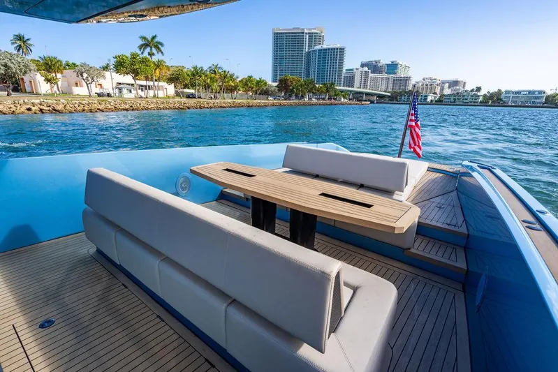 Elizabeth Yacht Photos Pics Wajer 55 S 2022 yacht with elegant seating, cruising near a coastal cityscape.