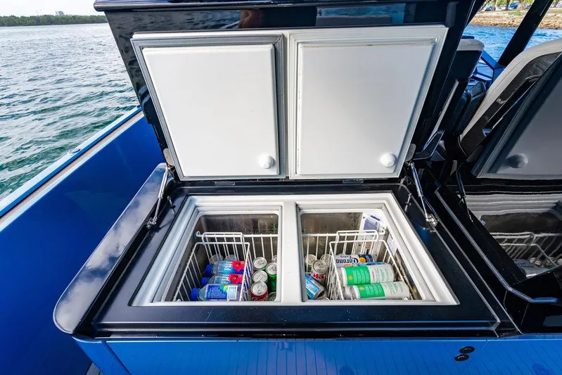 Elizabeth Yacht Photos Pics Open cooler on 2022 Wajer 55 S yacht, stocked with beverages, against a scenic water backdrop.