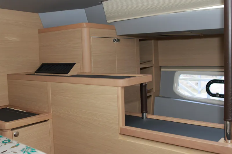  Yacht Photos Pics Interior of 2023 Aquila 44 Yacht featuring modern wood cabinetry and a window.