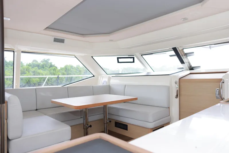  Yacht Photos Pics Interior of 2023 Aquila 44 Yacht with modern seating and panoramic windows.
