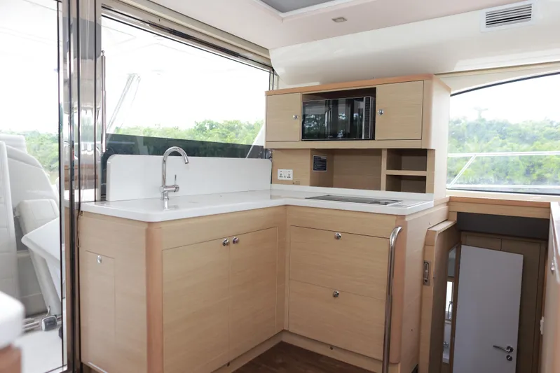  Yacht Photos Pics Modern kitchen area on 2023 Aquila 44 Yacht with sleek cabinetry and large windows.