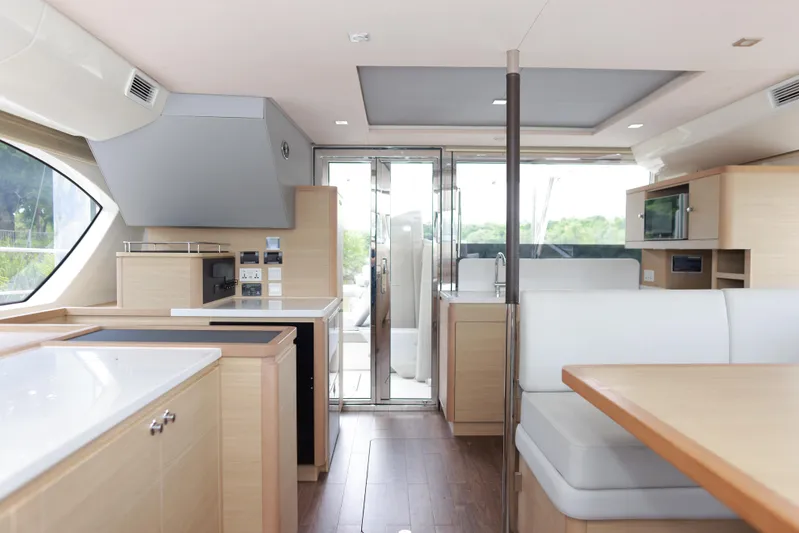  Yacht Photos Pics Luxurious interior of 2023 Aquila 44 Yacht with modern kitchen and seating area.
