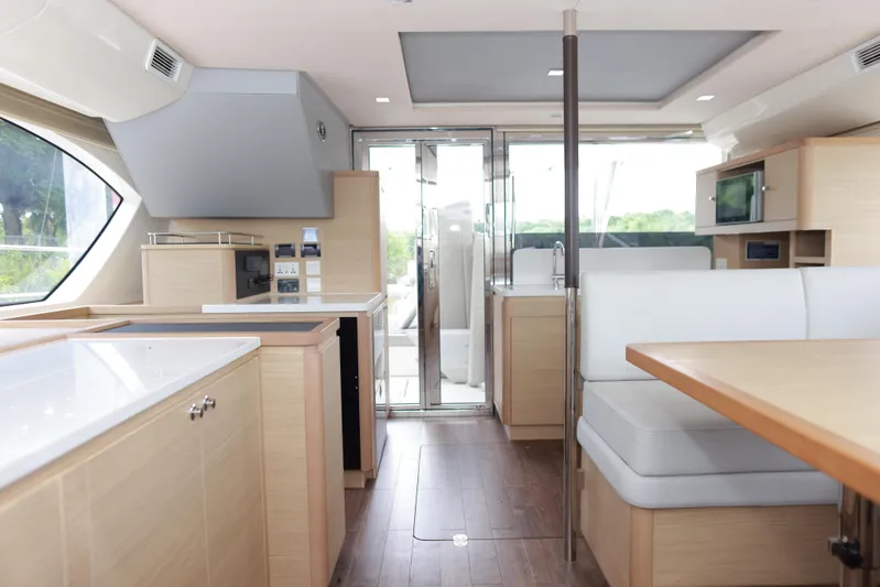  Yacht Photos Pics Modern interior of 2023 Aquila 44 Yacht with sleek kitchen and dining area.