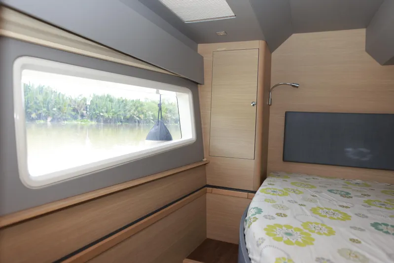  Yacht Photos Pics Interior cabin of 2023 Aquila 44 Yacht with window view and bed.