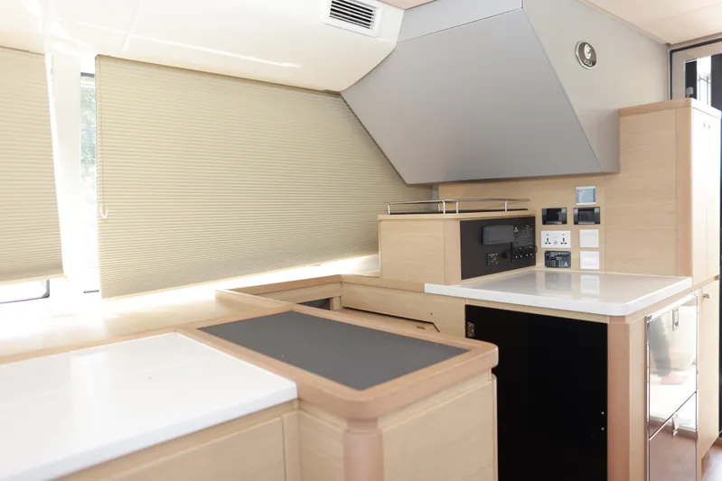  Yacht Photos Pics Modern kitchen interior of 2023 Aquila 44 Yacht with sleek cabinetry and appliances.