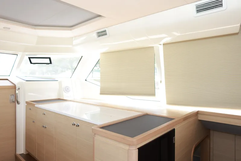  Yacht Photos Pics Interior of 2023 Aquila 44 Yacht with modern cabinetry and large windows.