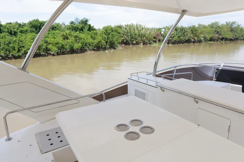  Yacht Photos Pics 2023 Aquila 44 Yacht deck overlooking calm river and lush greenery.