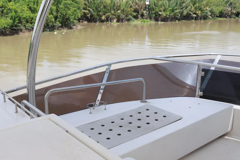  Yacht Photos Pics Aquila 44 Yacht 2023, deck view by a river with lush greenery.