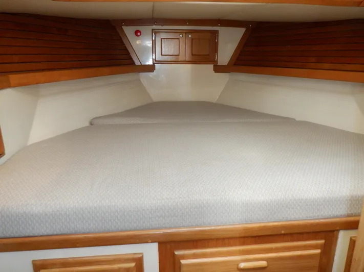 Tapawingo Yacht Photos Pics V-berth cabin interior of 1998 Pacific Seacraft 40 sailboat with wooden accents.