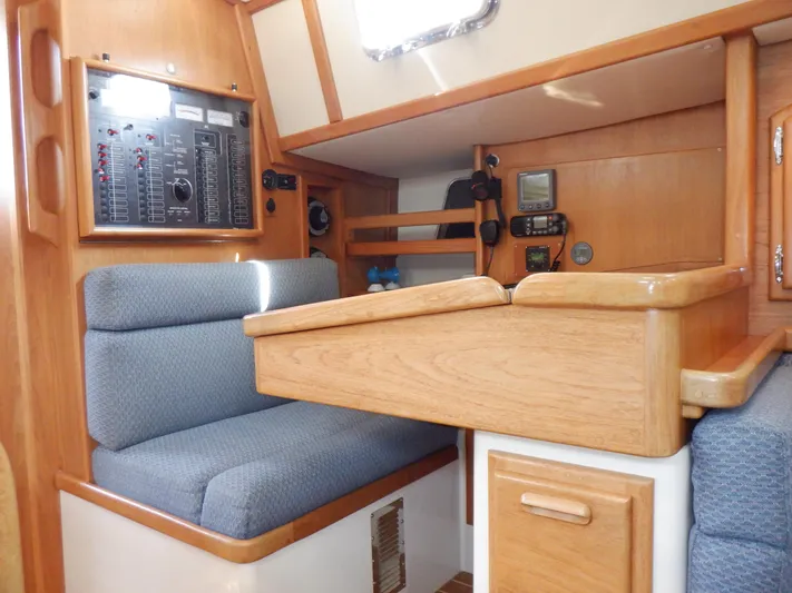 Tapawingo Yacht Photos Pics Interior of 1998 Pacific Seacraft 40 sailboat with navigation station and seating area.