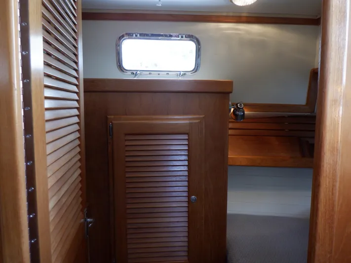 Tapawingo Yacht Photos Pics Interior view of 1998 Pacific Seacraft 40 sailboat with wooden cabinetry and window.