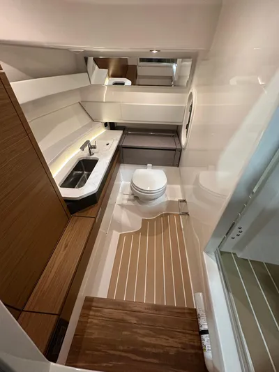 Tinkers Toye Yacht Photos Pics 2024 Tiara Yachts 34 LX bathroom with modern fixtures and wood accents.