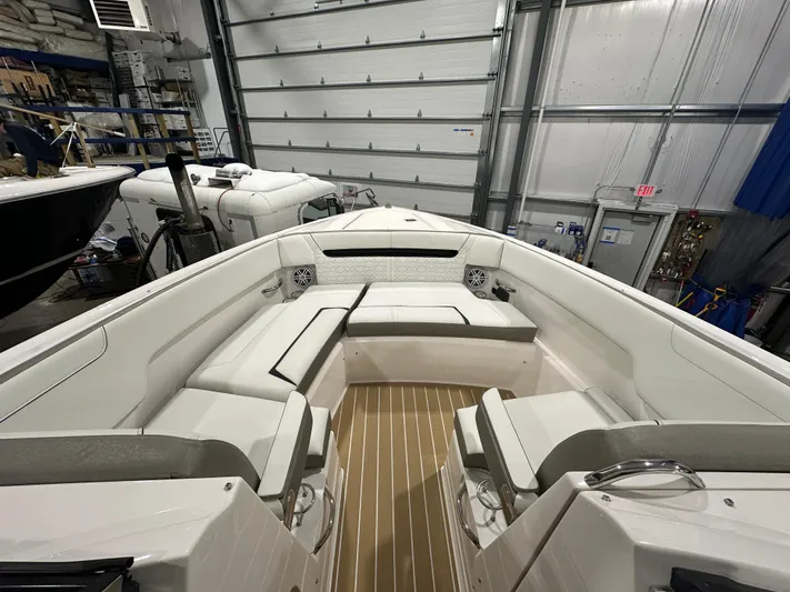 Tinkers Toye Yacht Photos Pics 2024 Tiara Yachts 34 LX interior with white seating and wood flooring in a garage.