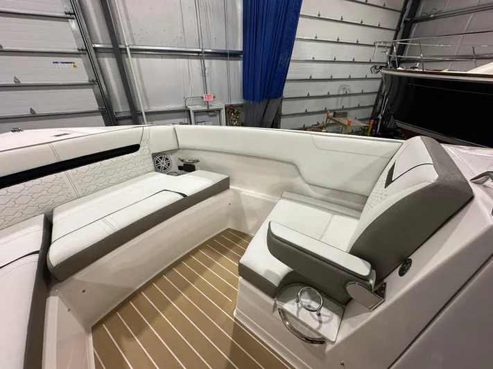 Tinkers Toye Yacht Photos Pics 2024 Tiara Yachts 34 LX interior with white seating and wood flooring in a garage setting.