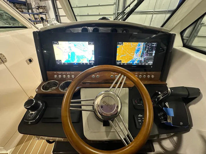 Tinkers Toye Yacht Photos Pics 2024 Tiara Yachts 34 LX helm with dual navigation screens and wooden steering wheel.