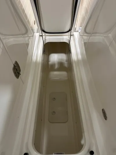 Tinkers Toye Yacht Photos Pics 2024 Tiara Yachts 34 LX storage compartment, open and empty, showcasing interior space.