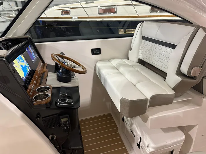 Tinkers Toye Yacht Photos Pics 2024 Tiara Yachts 34 LX helm with leather seating and modern navigation controls.