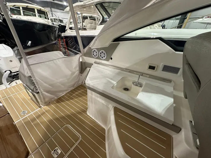 Tinkers Toye Yacht Photos Pics 2024 Tiara Yachts 34 LX interior with sleek design, featuring a compact sink and wooden flooring.