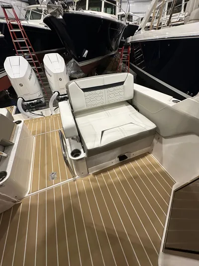 Tinkers Toye Yacht Photos Pics 2024 Tiara Yachts 34 LX interior with white seating and teak flooring.