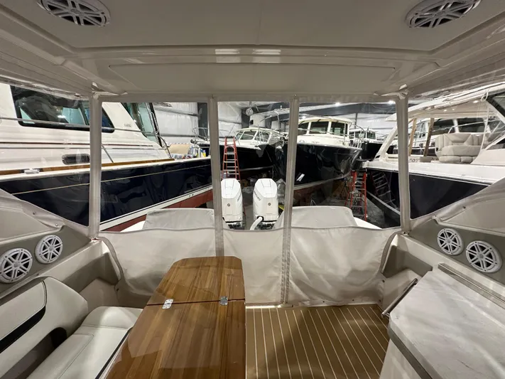 Tinkers Toye Yacht Photos Pics 2024 Tiara Yachts 34 LX interior with seating, table, and view of docked boats.