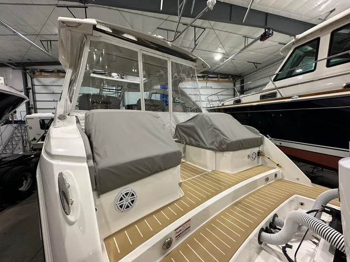 Tinkers Toye Yacht Photos Pics 2024 Tiara Yachts 34 LX with covered seating, docked indoors.