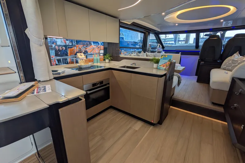  Yacht Photos Pics Luxurious interior of 2025 Absolute 52 FLY yacht with modern kitchen and seating area.