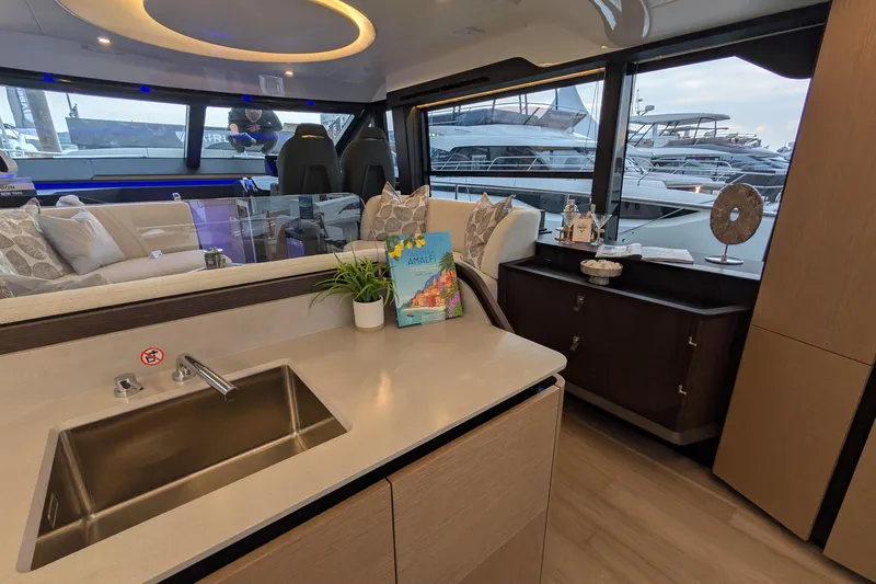  Yacht Photos Pics Luxurious interior of 2025 Absolute 52 FLY yacht with modern kitchen and elegant decor.