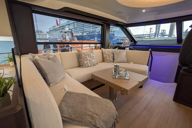  Yacht Photos Pics Luxurious interior of 2025 Absolute 52 FLY yacht with elegant seating and scenic window view.