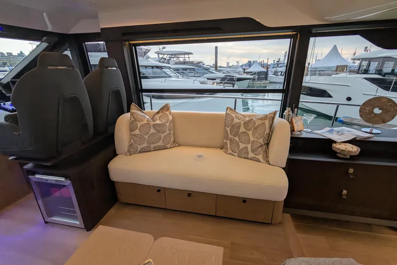  Yacht Photos Pics Luxurious interior of 2025 Absolute 52 FLY yacht with elegant seating and marina view.