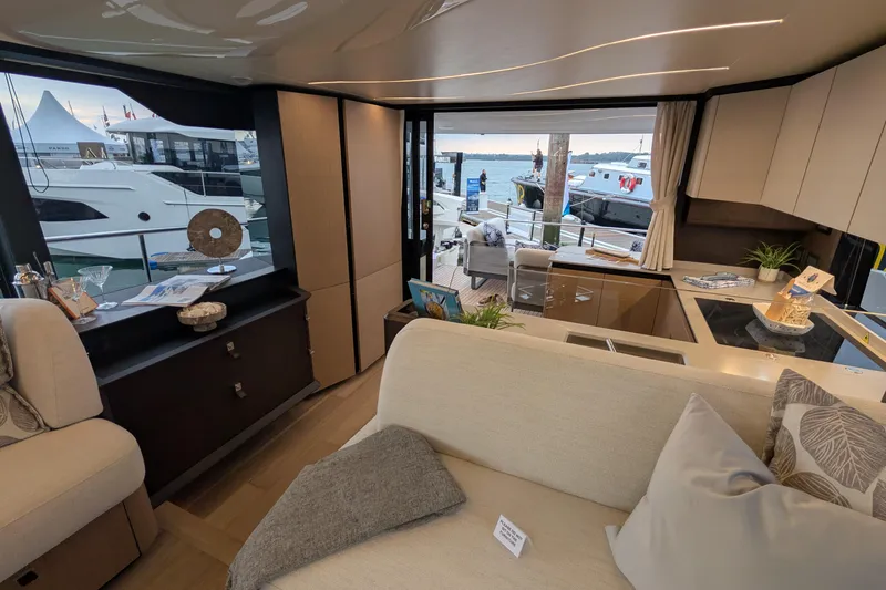  Yacht Photos Pics Luxurious interior of 2025 Absolute 52 FLY yacht with modern furnishings and marina view.