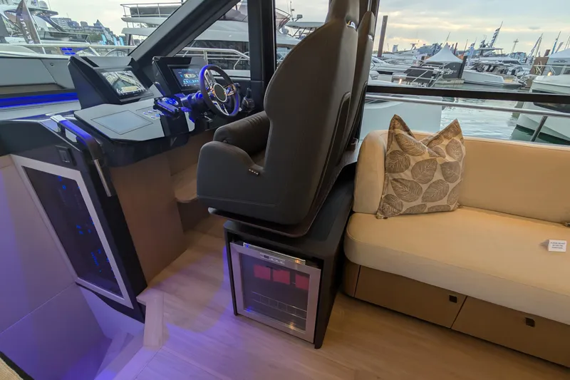  Yacht Photos Pics Interior of 2025 Absolute 52 FLY yacht with helm, seating, and marina view.
