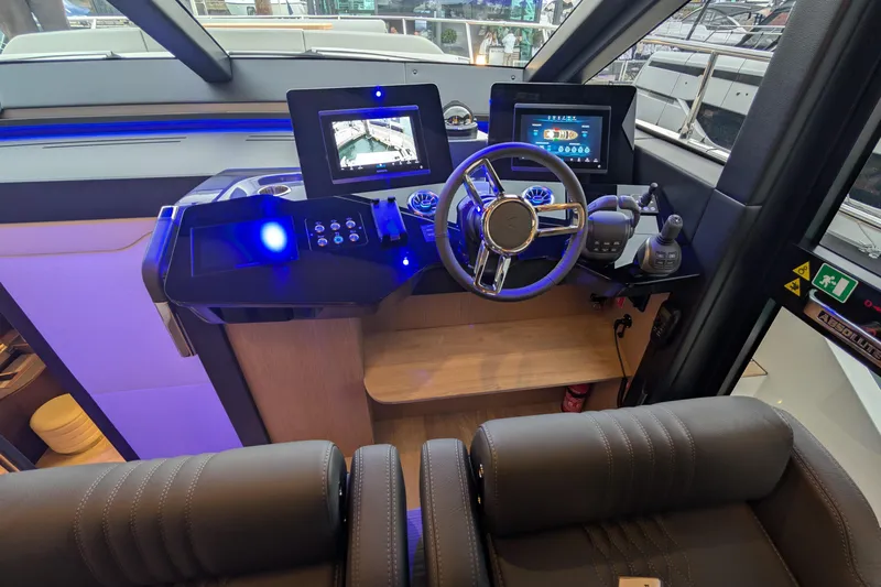  Yacht Photos Pics Helm of 2025 Absolute 52 FLY yacht with modern controls and navigation screens.