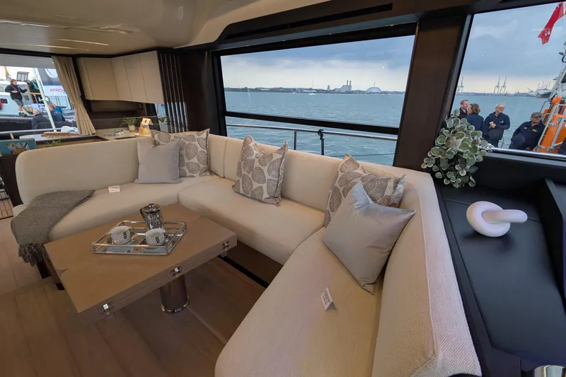  Yacht Photos Pics Luxurious interior of 2025 Absolute 52 FLY yacht with elegant seating and sea view.