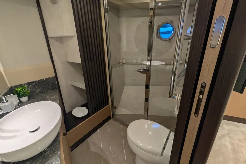 Yacht Photos Pics Luxurious bathroom on 2025 Absolute 52 FLY yacht with modern fixtures and elegant design.