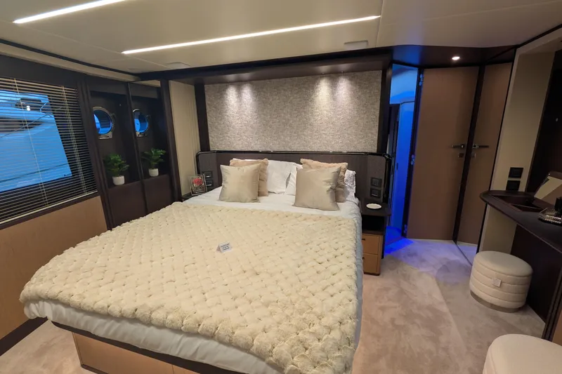  Yacht Photos Pics Luxurious bedroom interior of 2025 Absolute 52 FLY yacht with elegant decor and cozy bedding.