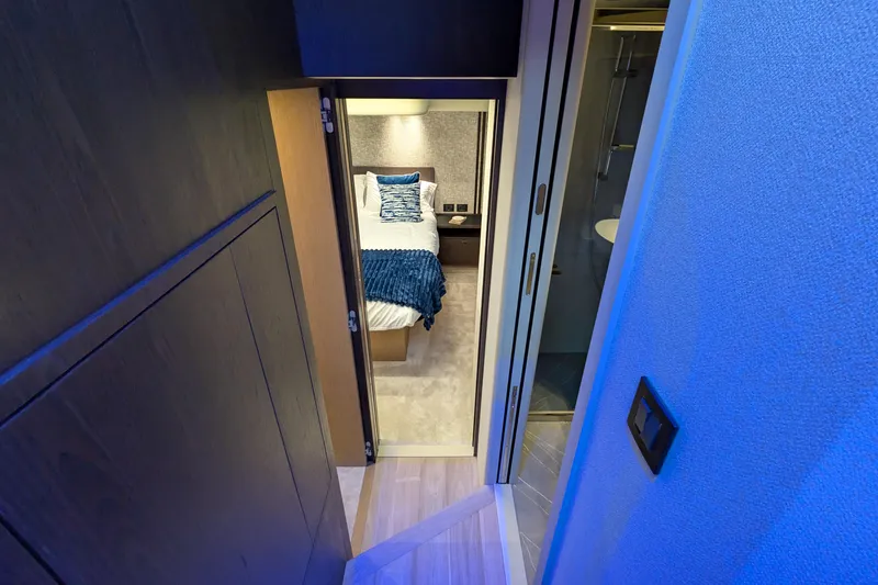  Yacht Photos Pics Interior view of Absolute 52 FLY 2025 yacht bedroom with modern design and blue lighting.